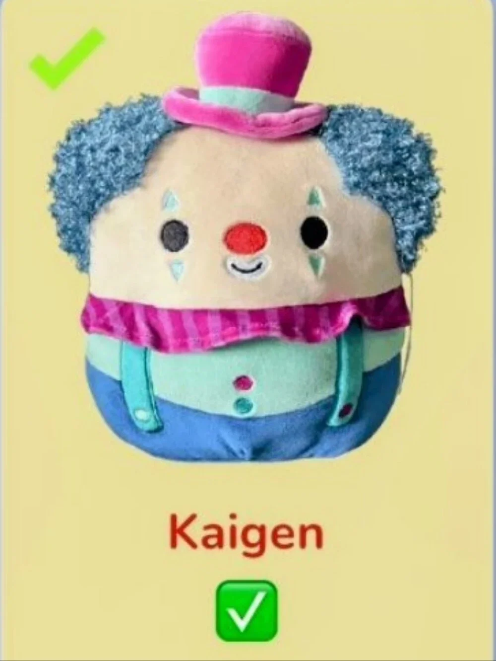 Squishmallows plush, Kaigen the Clown, identified by his blue, teal, and pink